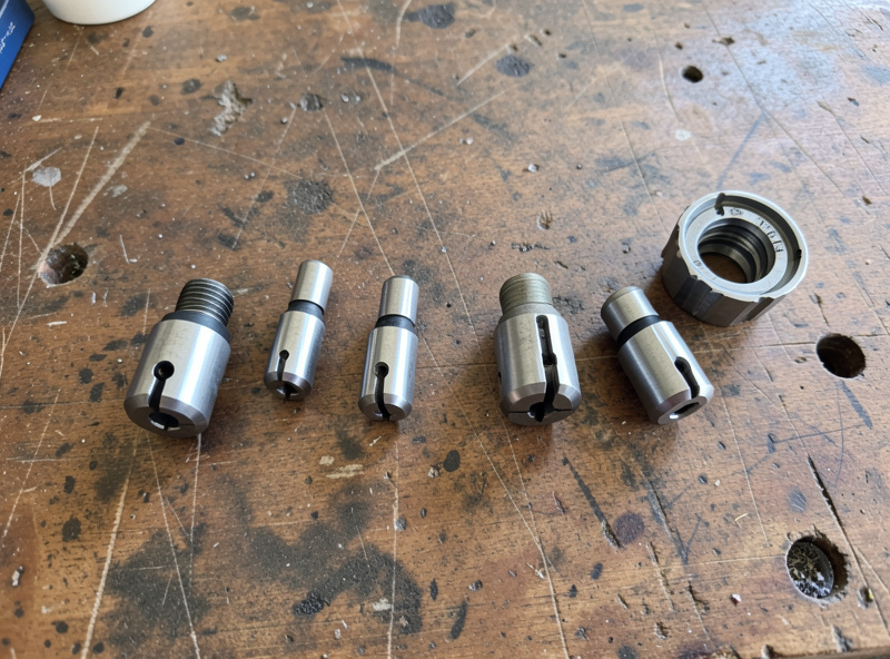 Set of ER collets arranged by size next to a spindle collet nut