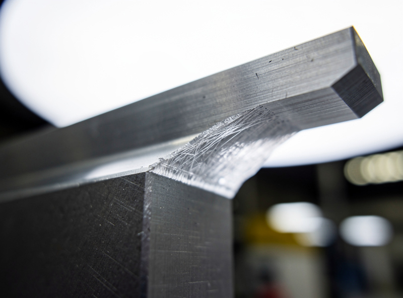 A CNC part connected to its stock by a thin onion-skin floor of material on the bottom before separation