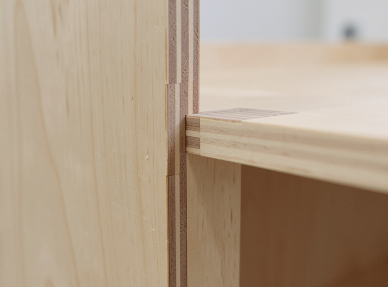 A rabbet cut along the back edge of a cabinet panel on a CNC router to seat a back panel